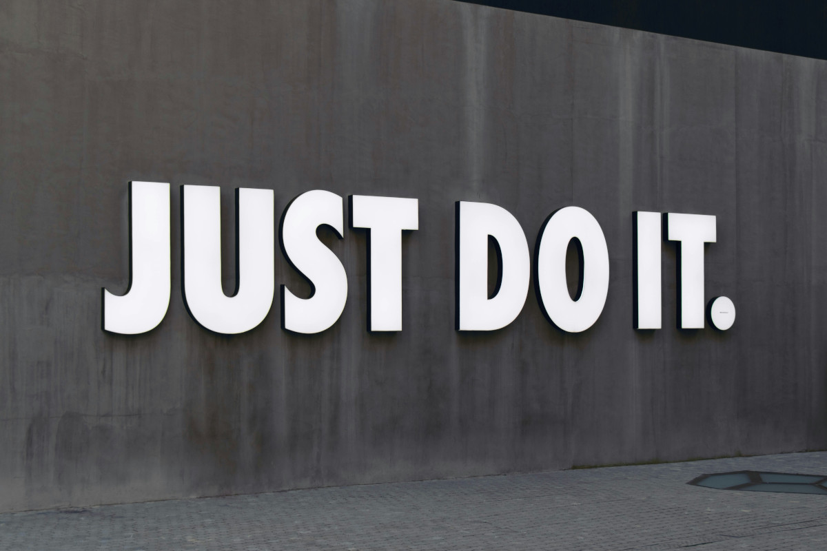 Murel of 'just do it' on a wall in black and white - inspiration to start now to generate online income for Gen X